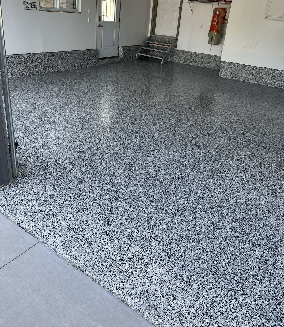 Garage floor coated in polyaspartic flooring by Pryce Designs